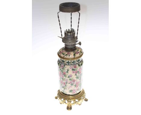 Gilt metal and pottery oil lamp with floral decoration