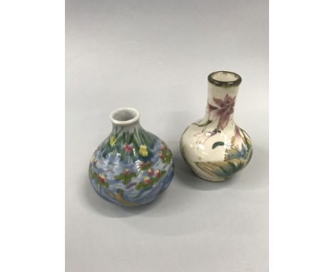 A Cobridge ceramic bottle shaped vase, decorated with flowers and leaves, impressed mark to underside.
