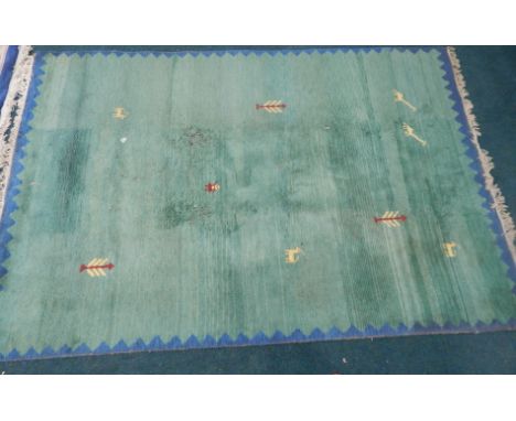 An Eastern style carpet, with a design of trees, camels, etc, green within a blue border. Provenance: Butterfields, Thoresby 