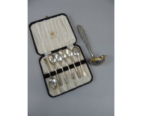 A white metal ladle, with filigree handle and shell and leaf cast bowl, maker's mark GJM, and a set of six cased teaspoons. (