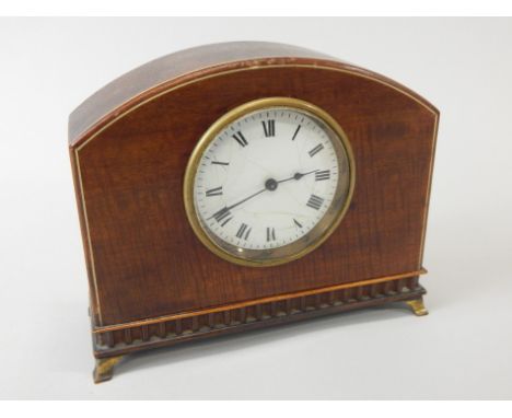 An Edwardian mahogany mantel clock, with a white enamel dial, on tapering brass feet, dial (AF), 21cm wide