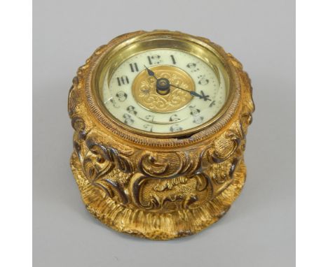 A late 19th/early 20thC French style gilt metal table clock, the enamel style dial with Arabic numerals, the case cast with s