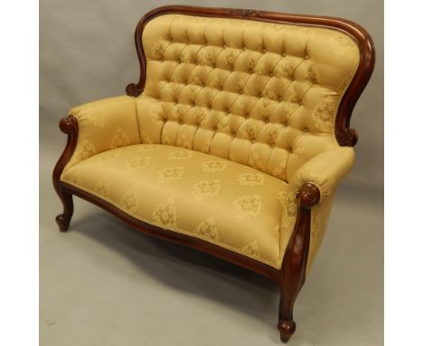 A modern mahogany finished two seater settee and button back gilt coloured material. The upholstery in this lot does not comp