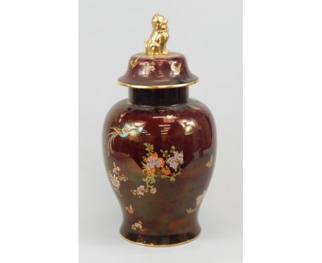 A Carltonware jar and cover, decorated in Oriental style with The Bird of Paradise and tree pattern in coloured enamels, on a