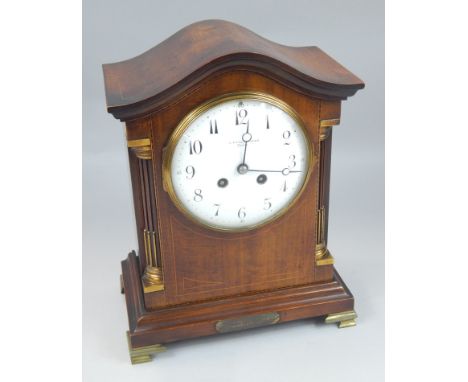An early 20thC mahogany boxwood strung and checker banded mantel clock, the white enamel dial signed J H Inglis & Sons York w