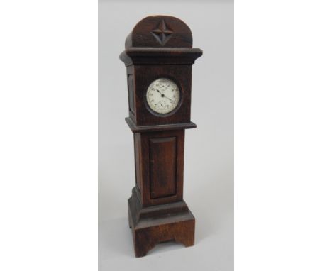 An early 20thC oak watch stand, modelled in the form of a longcase clock, inset with a Lemonia silver plate pocket watch, 11c