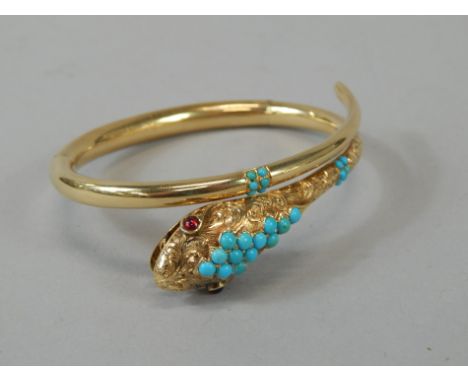 A ladies bracelet, formed as a serpent, part engine turned and set with scrolls, with a part turquoise head, the eyes picked 