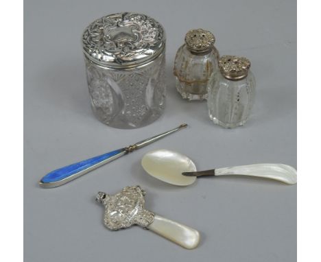 A collection of small silver, etc, to include two cut glass pepper pots, with silver mounts, a rattle, mother of pearl spoon,