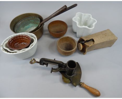 A collection of kitchenalia, to include two brass pans, a Magic marmalade cutter, various jelly moulds, to include a stonewar