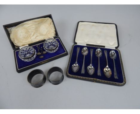 A collection of small silver, to include a pair of engine turned napkin rings, a pair of cut glass salts with silver mounts, 