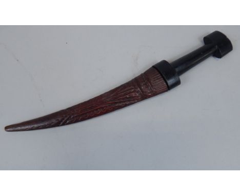 An Eastern dagger, with a shaped blade, and ebonised handle.