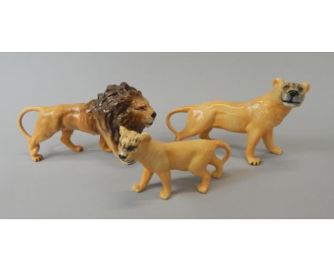 Three Beswick ceramic figures, a lion, a lioness and a cub