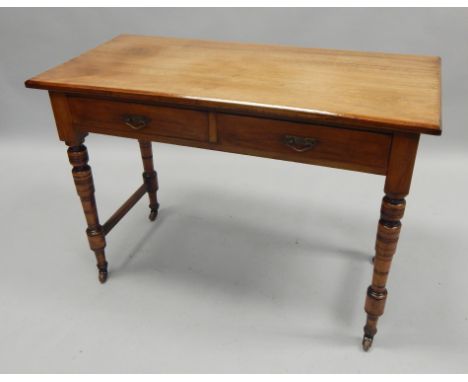 A Victorian walnut side table, the rectangular top above two frieze drawers, on turned tapering legs with ceramic castors, 10
