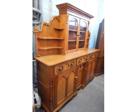 A Victorian pitch pine and later oak pine simulated oak dresser, the associated raised back with two glazed doors, flanked by