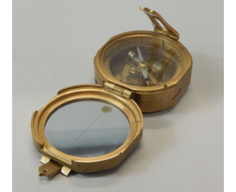 A reproduction brass nautical compass, 7cm wide