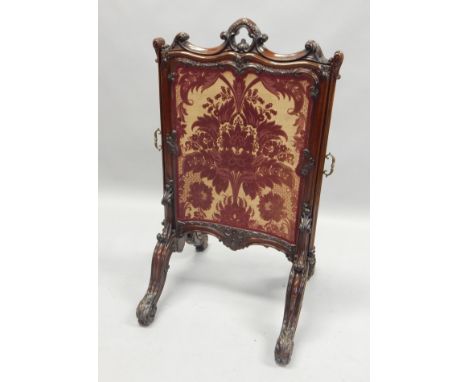 A Victorian rosewood firescreen, with three pull out sections upholstered in purple and cream damask type fabric, the frame c