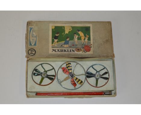 A BOXED MARKLIN TINPLATE SPINNING TOP SET, three tops with butterfly and dragonfly designs, have some wear, box complete, but