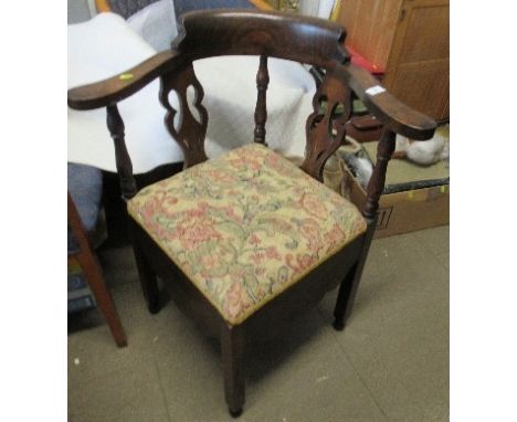 A Georgian design oak corner commode chair, with pierced splats
