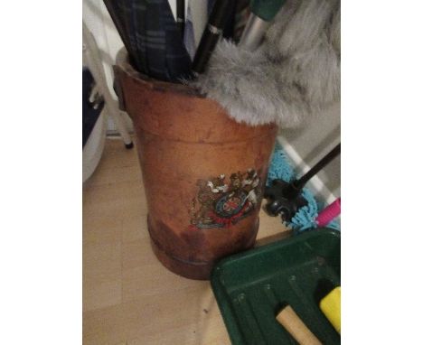 A leather artillery shell case, decorated with a crest, used as a stick stand, height 14.5ins