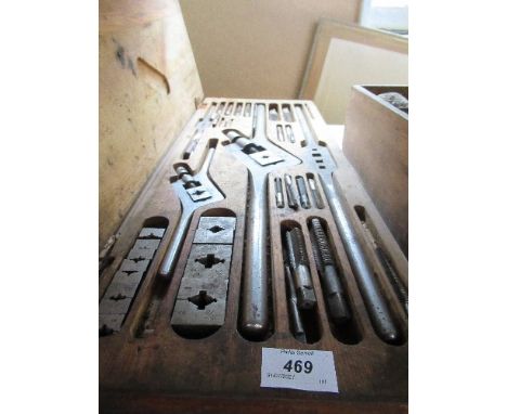 A cased set of tools for drill bits, together with a box containing knobs, handles, etc.