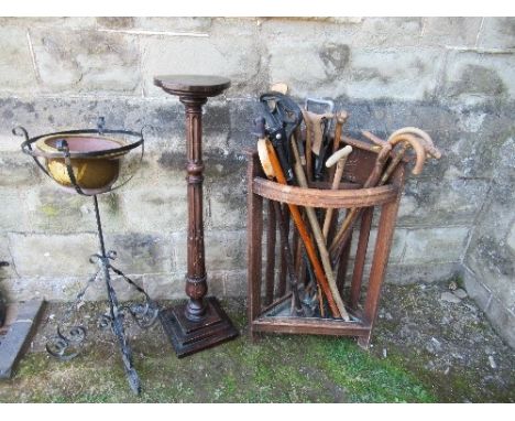 A stick stand with sticks, together with a mahogany jardinière stand and a wrought iron example