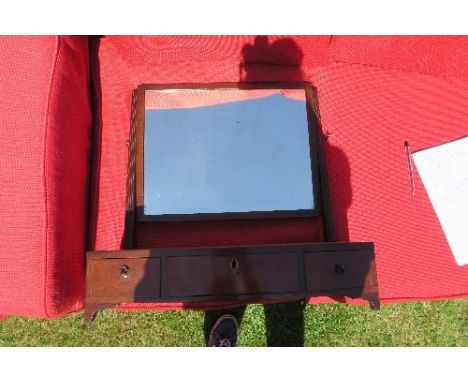 A mahogany swing frame toilet mirror, the bow base fitted with three drawers, width 34ins, height 44ins, depth 11.5ins