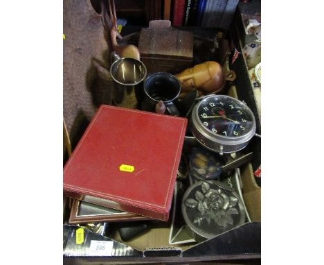 A box of sundries, including money box, lighters, Goliath repeater alarm clock, brass metalware, etc.