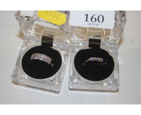 A 925 ring set with light pink stones; and another 925 ring with purple and green stones 