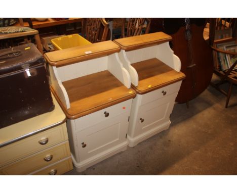 A pair of light oak and painted bedside cabinets