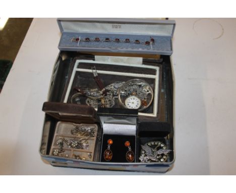 A tin of silver and white metal jewellery to include a fob watch, a bangle, ear-rings, two wrist watches etc.