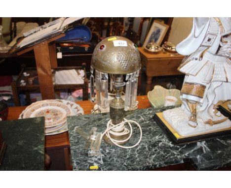 A brass table lamp and shade hung with prism glass drops 