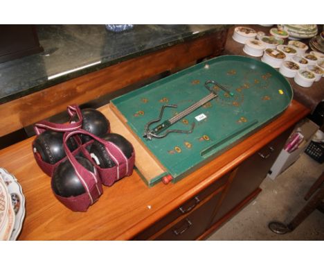 A bagatelle board; and four bowling woods 