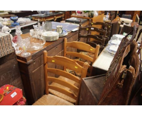 A pair of pine ladder back chairs and one other pair of ladder back chairs