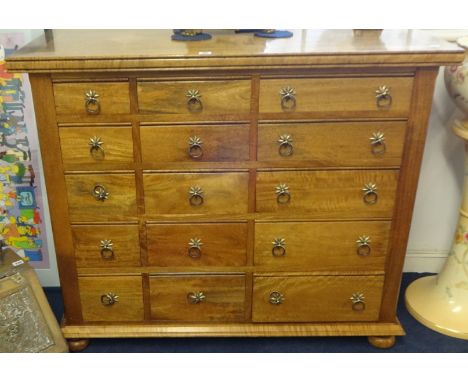 A modern mango wood chest fitted with fifteen drawers, width 115cm x 96cm height x depth 50cm purchased from Freedman's of To