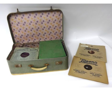 A cased collection of 78 records and record player.