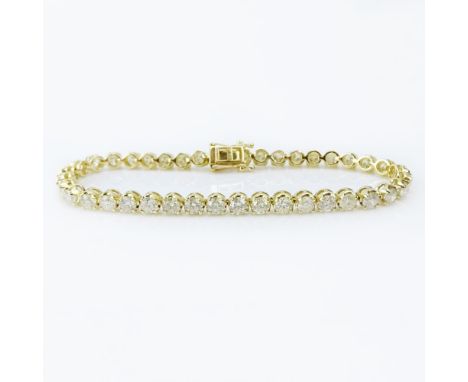 AIG Certified 8.52 Carat Round Brilliant Cut Diamond and 18 Karat Yellow Gold Tennis Bracelet. Diamonds K-M color, I1-I2 clar