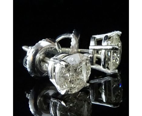 AIG Certified Pair of 1.52 Carat Round Brilliant Cut Diamond and 14 Karat White Gold Ear Studs. Diamonds K color, I2 clarity.