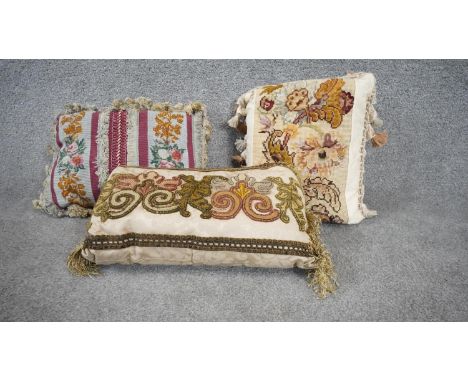 Three 20th century tapestry floral design cushions with silk tassle edging. One with a raspberry silk reverse.  H.23 W.42 D.2