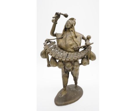 A bronze sculpture of a Tribal Balafon player. H.37 W.20 