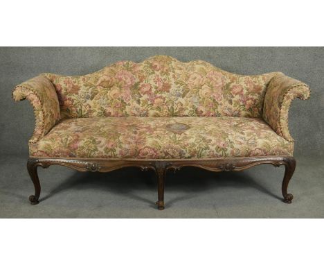 A 19th century style shaped back sofa in tapestry upholstery on carved scrolling apron and cabriole supports. H.90 L.190 D.80