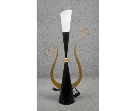 A mid century black and gilded abstract table lamp with gold tendrils and frosted conical shade. H.70cm 