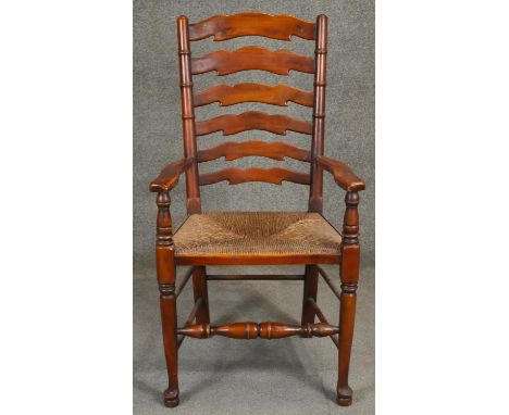 A 19th century style fruitwood ladder back armchair. H.106cm 