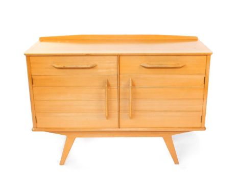 A Donald Gomme G-Plan 1950's light oak and beech sideboard, with a pair of drawers, one lined, over a pair of cupboard doors,