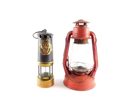 A Tornedo Tilley lamp, 35cm high., together with a cast iron brass and copper miner's lamp, 28cm high. (2)