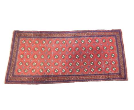 A Caucasian runner, red ground decorated with five rows of green and white guls, interspersed with floral motifs, within repe