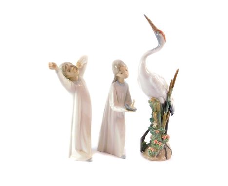 A Lladro porcelain figure of a crane, modelled standing against rushes and flowers, 29cm high., together with a figure of a g