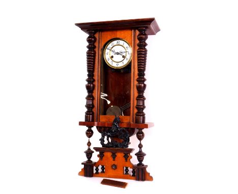 A Continental late 19thC mahogany cased wall clock, circular enamel dial bearing Arabic numerals, eight day movement with coi