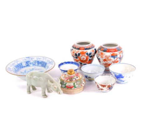Four Qing dynasty porcelain tea bowls, blue and white bowl, Celadon figure of buffalo and a Cantonese porcelain lid, together