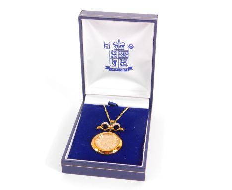 A Queen Elizabeth II gold half sovereign 2002, in a 9ct gold circular and bow surmounted pendant mount, set with diamonds and