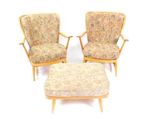 An Ercol light oak and beech three piece Windsor suite, comprising a pair of comb back armchairs, with floral pattern loose c